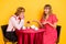 Photo portrait of lovely couple spending time on valentines day conversation drinking tea happy isolated vivid yellow