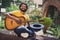 Photo portrait of man keeping headwear for money playing guitar sitting on green street in summer smiling in glasses