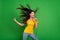 Photo portrait of overjoyed girl with long brunette hair singing karaoke at party isolated vibrant green color