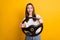 Photo portrait of pretty brunette girl keeping steering wheel learning to drive smiling isolated vibrant yellow color