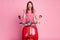 Photo portrait of pretty girl sitting on red moped gesturing like winner of race isolated on pastel pink color