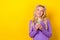 Photo portrait of pretty young girl device look interested empty space dressed stylish violet garment isolated on yellow