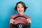 Photo portrait of pretty young girl hold steering wheel excited driver wear trendy striped outfit isolated on blue color