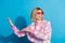 Photo portrait of pretty young girl sunglass celebrate party dancing wear trendy pink outfit isolated on blue color