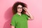 Photo portrait of pretty young girl touch specs serious specialist wear trendy green outfit isolated on pink color