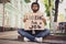 Photo portrait of sad grumpy man holding carton table looking for job need new work money sitting on ground