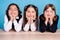 Photo portrait school mates smiling in uniform sitting at table tired after lessons isolated pastel blue color