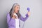 Photo portrait of senior mad furious stressed woman shouting screaming loudly keeping handset of retro violet phone with