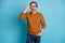 Photo portrait of serious confident man wearing glasses brown warm sweater isolated on vivid blue color background