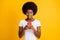 Photo portrait of shocked astonished african american woman holding phone in both hands wearing white t-shirt isolated