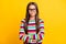 Photo portrait of smiling little girl wearing casual striped jumper spectacles with folded hands isolated on vivid