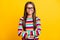 Photo portrait of smiling little girl wearing colorful striped jumper with crossed hands isolated on vibrant yellow