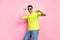 Photo portrait smiling man wearing bright t-shirt sunglass overjoyed dancing isolated pastel pink color background