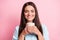 Photo portrait of smiling pretty woman enjoying scent of hot coffee cup isolated on pastel pink color background