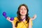 Photo portrait of unhappy girl with telephone in hand wire around neck isolated on pastel light blue colored background