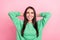 Photo portrait of young optimistic charming brunette hair woman green jumper hands head looking up empty space news