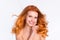 Photo portrait of young woman wavy red hair happy smiling touching face tender ideal smooth skin isolated white color