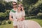 Photo portriat young couple smiling in summer going in park in stylish outfits wearing sunglass