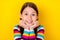 Photo of positive adorable little lady hands cheeks shiny smile wear striped shirt isolated yellow color background