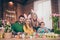 Photo of positive cheerful four people enjoy paint eggs prepare easter basket house indoors