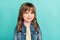 Photo of positive cheerful little girl toothy white smile wear jeans jacket  aquamarine color background