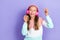 Photo of positive cool girl meloman look empty space promo sale shop modern technology ear accessory isolated on purple