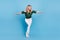 Photo of positive dancer lady plane pose enjoy rest wear bear shoulders green blouse isolated blue color background