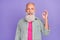 Photo of positive funky granddad hand fingers demonstrate okey symbol isolated on violet color background