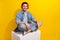 Photo of positive funky guy wear denim jacket sitting white platform listening music empty space isolated yellow color