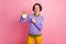 Photo of positive girl point index finger clock wear purple yellow pants trousers isolated pastel color background