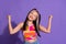 Photo of positive glad girl wear trendy clothes celebrate success isolated on purple color background