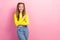 Photo of positive impressed schoolgirl with ponytails dressed yellow long sleeve directing empty space isolated on