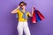 Photo of positive lovely lady wear yellow trendy summer clothes hold packs nice shopping isolated on purple color