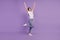 Photo of positive lucky girl raise fists win isolated over purple background