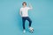 Photo of positive man football winner holding soccer ball isolated blue background