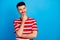 Photo of positive minded young man look empty space dream hold hand chin plan isolated on blue color background