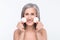 Photo of positive nice old woman hold cotton pads smile good mood skin care isolated on grey color background