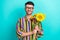 Photo of positive nice person beaming smile hands hold bunch sunflowers isolated on aquamarine color background