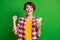 Photo of positive person fist up success subscribe hold gadget plaid outfit isolated on green color background