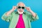 Photo of positive retired cheerful old grandparent wear cool sunglass enjoy summer isolated on blue color background