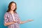 Photo of positive school girl hands palms hold showing offer beaming smile isolated on blue color background