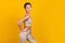 Photo of positive tender lady hand waist posing beaming smile wear grey top  yellow color background