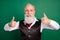 Photo of positive well-dressed man raise thumbs up wear formalwear striped waistcoat on green color background