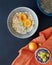 Photo, poster about healthy eating, breakfast of oatmeal in bowl, peaches, apricots, grapes on a dark background.