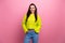 Photo of pretty adorable lady wear neon yellow pullover arms hands pockets smiling isolated pink color background