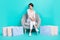 Photo of pretty adorable lady wear trendy clothes outfit sit cozy chair fitting room satisfied purchase isolated on cyan