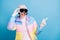 Photo of pretty amazed lady point finger copyspace wear hat white gloves mask isolated on blue color background