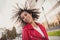 Photo of pretty charming wavy lady wear red jacket smiling wind blowing curls outside urban city street