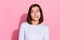 Photo of pretty doubtful young lady dressed white jumper biting lip looking empty space isolated pink color background