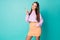 Photo of pretty funny lady hold lollipop candy hands good mood sweets addicted person wear cropped pullover orange short